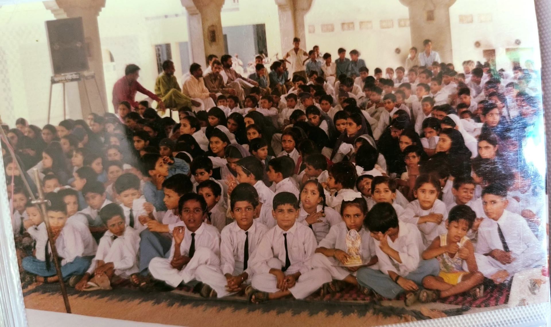 Boys' batch group portrait under the Gurmukhi arch with management